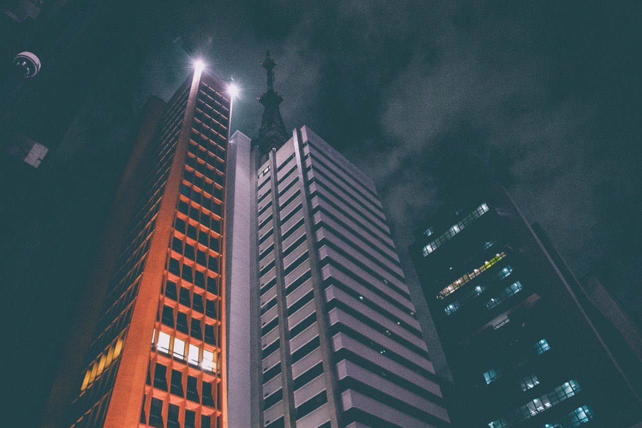 Tall buildings looking up at night, city lights